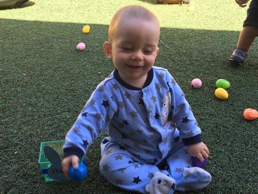 He completely loves being at Tiny Tots!  This was taken in their Tiny Turtles Play Yard - complete with a "grass" mat to play on!