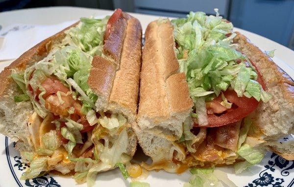 Ali's Buffalo chicken club sub.  Garlic grilled sub roll, chicken, lettuce, tomato, bacon & home made Buffalo sauce w blue cheese dressing