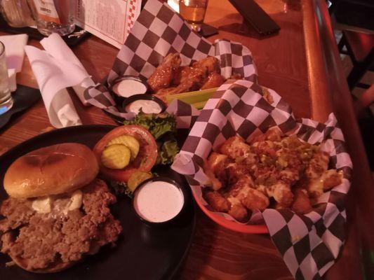 Turkey Smash burger with Loaded tater tots, generously smothered in Queso, bacon bits and diced jalapeños Hot wings 10 out of 10!