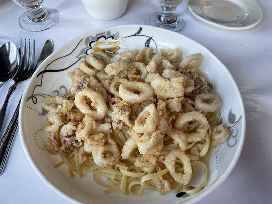 Fried calamari over linguine with garlic and oil. So crispy and yet incredibly tender.