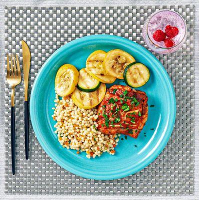 Cage Free Chicken Karahi, served with Tri-Colored Pearl Couscous, Grilled Organic Zucchini and Yellow Squash.