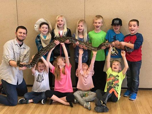 The whole gang helping to hold Brucinda the TEN FOOT Burmese python!