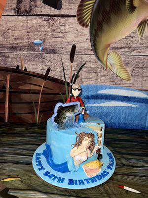 Custom cake for surprise birthday of avid fishing enthusiast. Mermaid is pulling the fishing line!