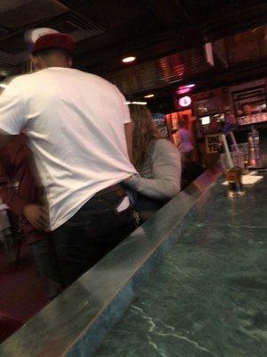 This woman was practically MOLESTING this younger dude at the bar