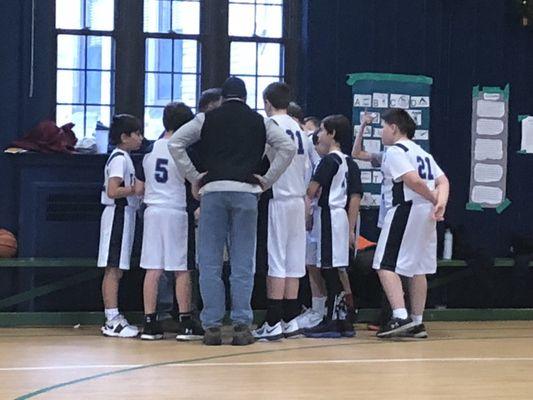 Boys JV Basketball Team in a Huddle