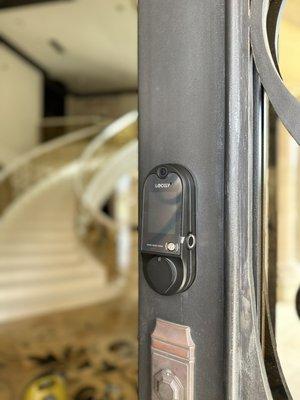 Smart lock installation on metal house entry door.