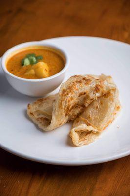 Roti Canai ( Indian flat bread ) with coconut curry and potatoes