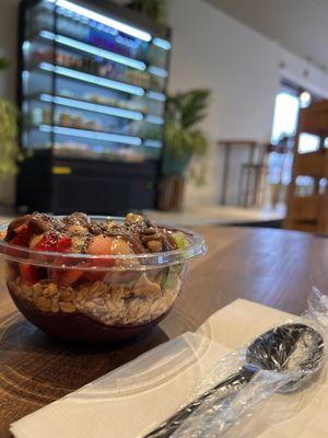 Acai bowl with granola, strawberries, kiwi, peanut butter, Nutella and chia seeds.