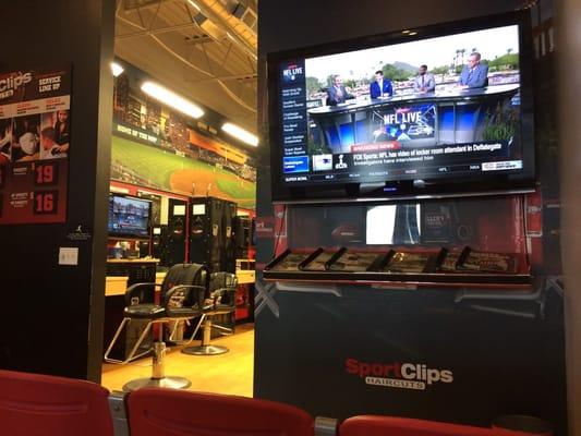 Waiting area with benches, ESPN on TV and sports lockers. Definitely a guys' place!