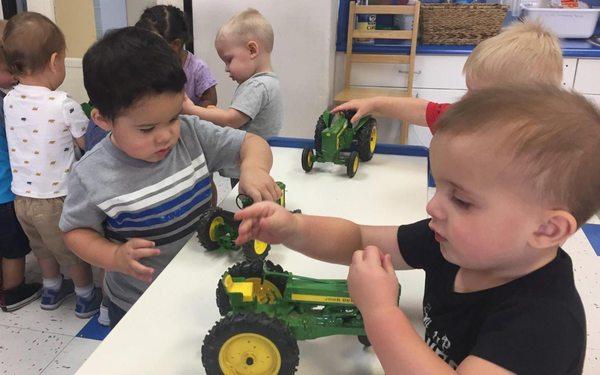 Preschool Boys Playing with John Deere Tractors