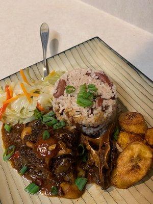 Oxtails, steamed Jamaican Cabbage, rice & peas, and fried plantains.