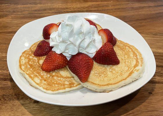 Strawberry Pancakes: Three Fluffy Buttermilk Pancakes, topped with Fresh Strawberries and whipped cream.