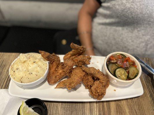 Chicken wings, mashed potatoes, and Seasonal Vegetables