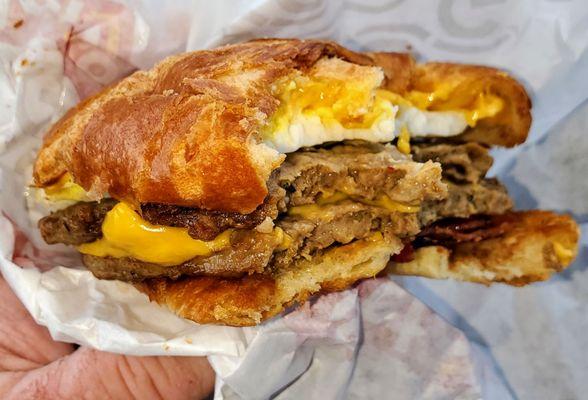 Breakfast sandwich - double sausage, bacon, fried egg, American cheese, on a croissant. Sorry about the bites, but it was good!