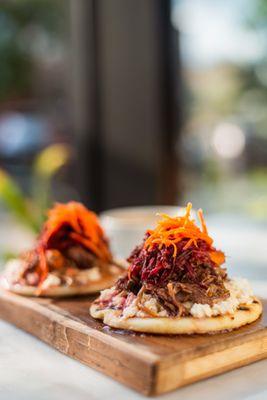 Coffee Braised Short Rib Beef Arepaski with a beet and carrot slaw on top