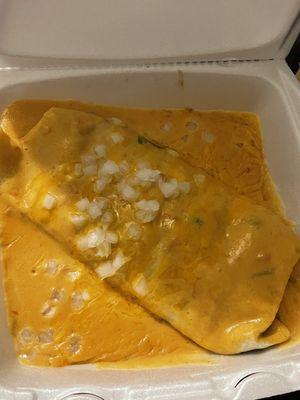 Combo burrito topped with cheese dip