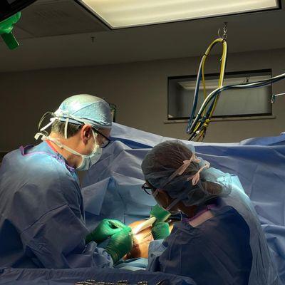 Dr. Gary D. Breslow and Maddison Keppler, PA-C in surgery performing Breast Implant Exchange