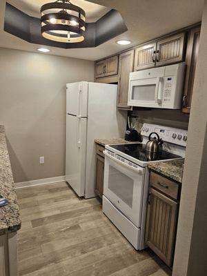 Small kitchen but perfect for a weekend getaway. Equipped with pots and pans, cutlery and plates, cups, and dishwasher.