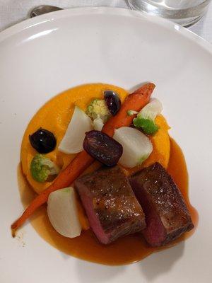 Hudson Valley lamb loin with saffron infused carrot puree, fall market vegetables, pickled grapes and grape reduction sauce