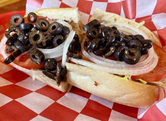 Turkey hoagie with a lot of black olives