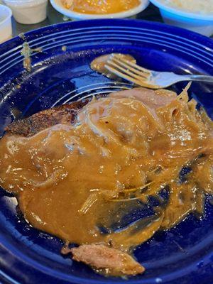 Super thin sliced beef liver with goopy brown gravy.