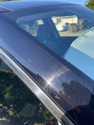 Scratches on gloss black exterior near the windshield.