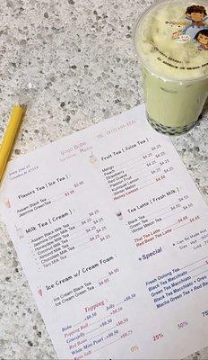 Honeydew Milk Tea (topped with Boba) and a copy of the menu