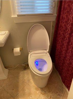 Moved water supply line and repositioned electronic toilet for installation.