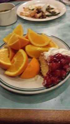 Fresh oranges and cherry cake