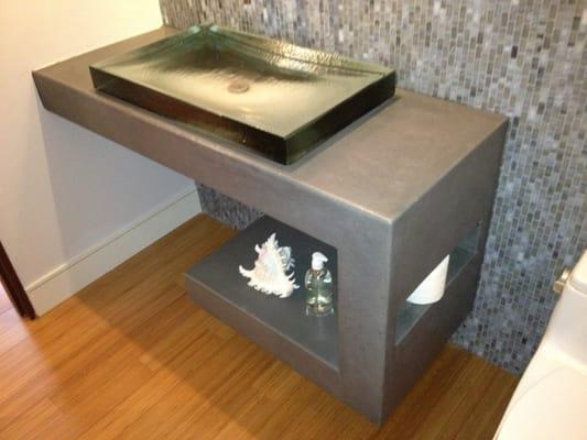 Concrete vanity with toilet paper shelf