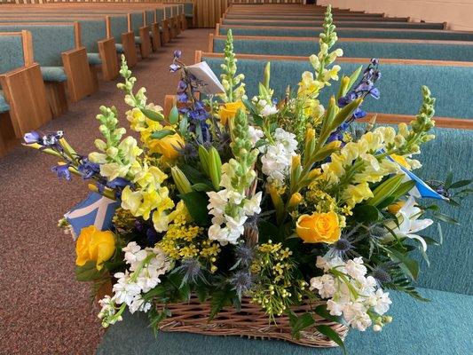 Funeral flowers. I asked for blue, yellow, and white, thistle, and gave them Scotland flags to add in.