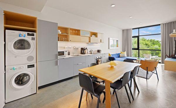 Kitchen, dining area, and in-unit laundry.