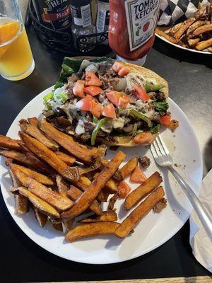 Philly cheesesteak and awesome fries.  Heck ya