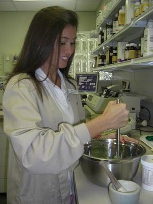 Megan, a Pharmacy Technician, is compounding multiple drugs to create "Wonder Cream" for a customer.