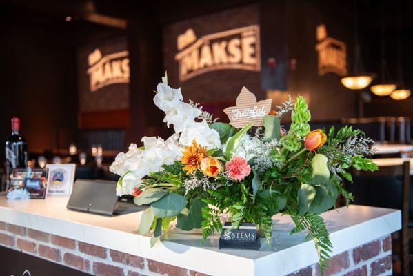 Beautiful floral display by Stems Floral at Mäksē Restaurant, adding a warm welcome for our guests