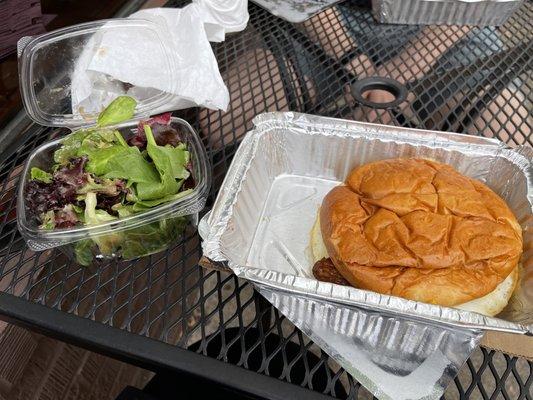 Breakfast sandwich with sausage and side salad