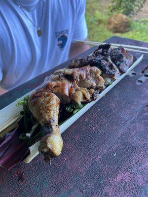 Smoked chicken and pork served over rice and greens