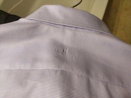 Another shirt with safety pin taken out and the damage is visible