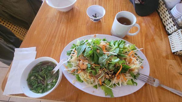 Papaya Salad with shrimp, tea, and phó broth to drink.