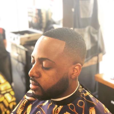 Mid-bald fade with a beard trim.