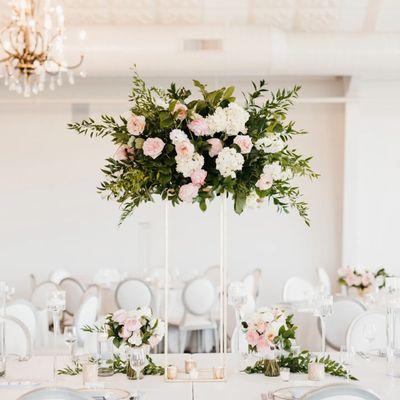 This bridal bouquet is a symphony of white and blush roses, delicate peonies, and trailing greenery, offered by CHIC SF Floral Design Studio