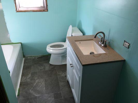 New bathtub, tub/shower valve, vanity with faucet, and new kohler toilet installation.