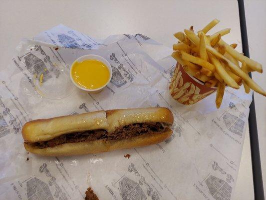 Cheesesteak  with provolone and cheese fries.