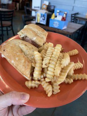 The Cuban sandwich with a side of fries.