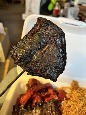 Burnt teriyaki on  a stick. So burnt it was black! Texture of jerky.