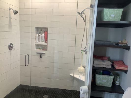 Remodeled bathroom to a very nice shower with two shower heads, Euro Glass.