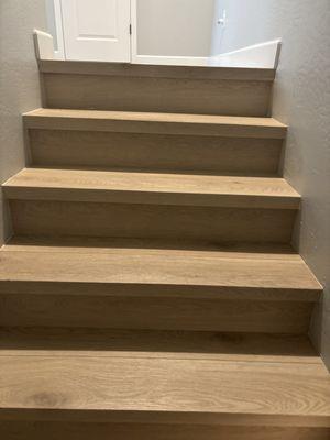 Stairs look great and I love how the planks encompass the stair, no horrible stair noses