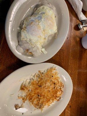 Biscuits and Sausage Gravy Breakfast with over easy eggs and side of hash browns