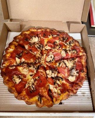 Large pepperoni and mushroom pizza