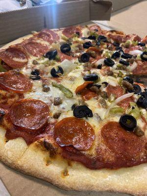 Combination pizza with pepperoni, sausage, black olives, green bell peppers and onions